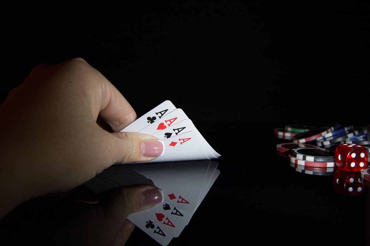 cards-in-hand-and-casino-chips